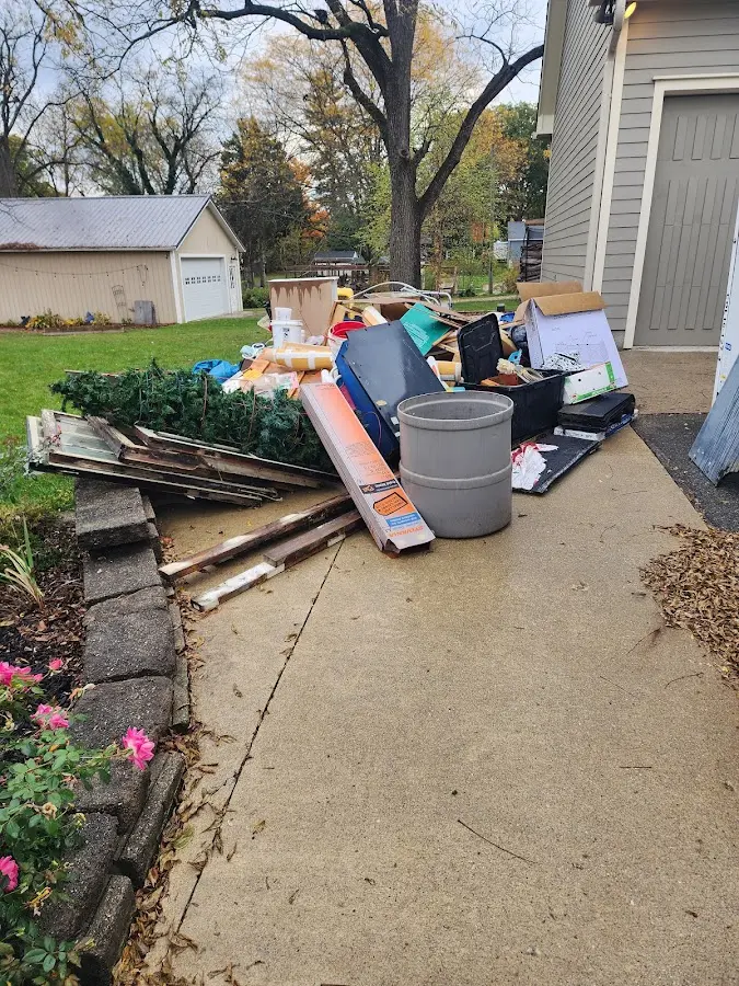 Dumpster being loaded with debris for Roofing Dumpster Rental in Hoosick